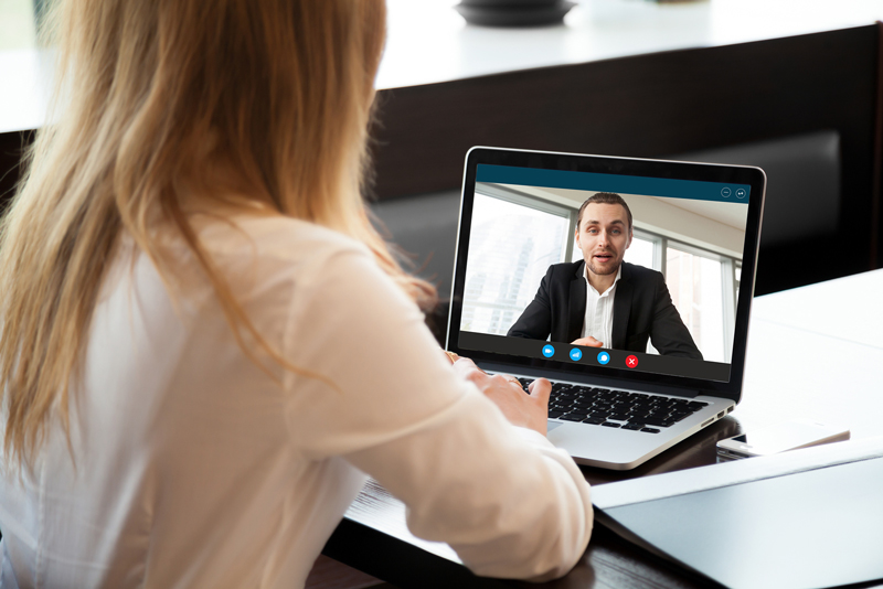 Woman on a business zoom video call with professional looking man