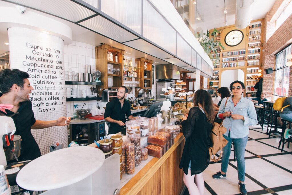 Barista coworkers making eye contact and laughing