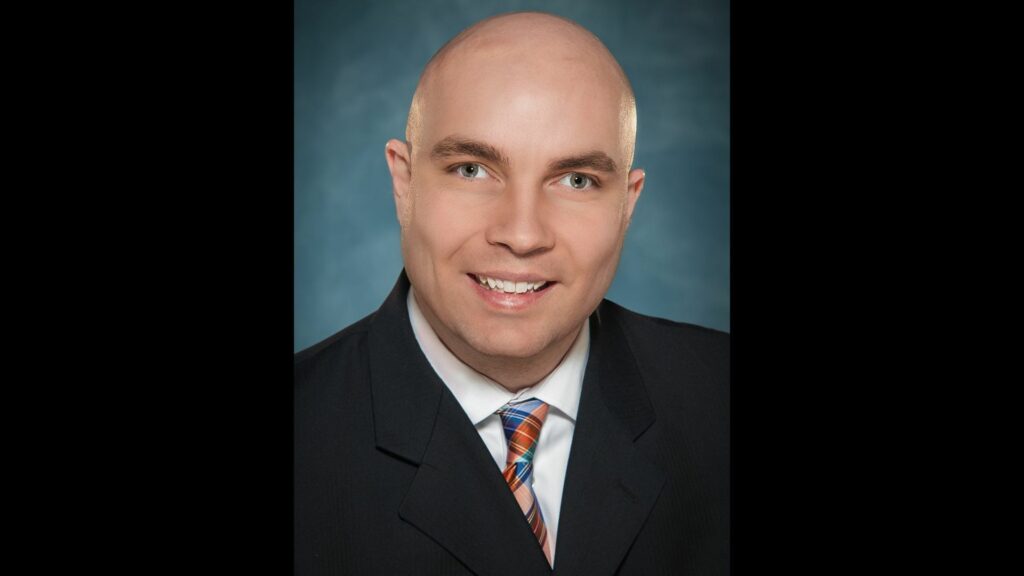 professional headshot of individual with light eyes wearing a suit