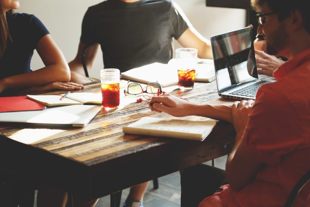 Group of students working and talking while seated at a table